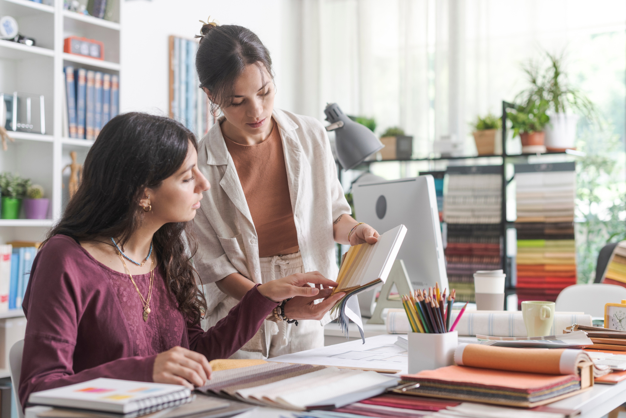 Two women looking over interior design business items